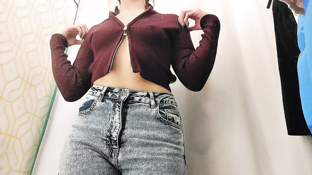 College girl in the fitting room of the store